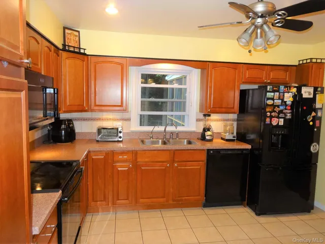 a kitchen with stainless steel appliances granite countertop a sink and cabinets