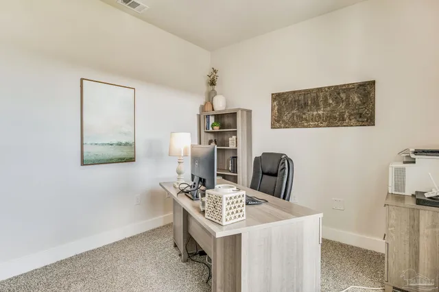 a bedroom with a large bed and windows