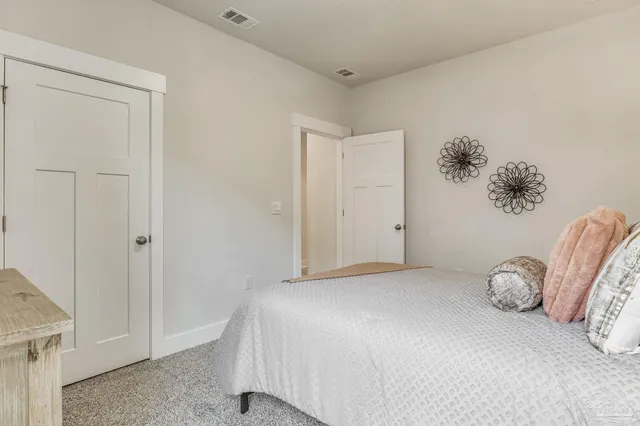 a bedroom with a bed and flowerpot