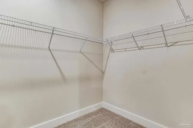 a living room kitchen with furniture and a wooden floor