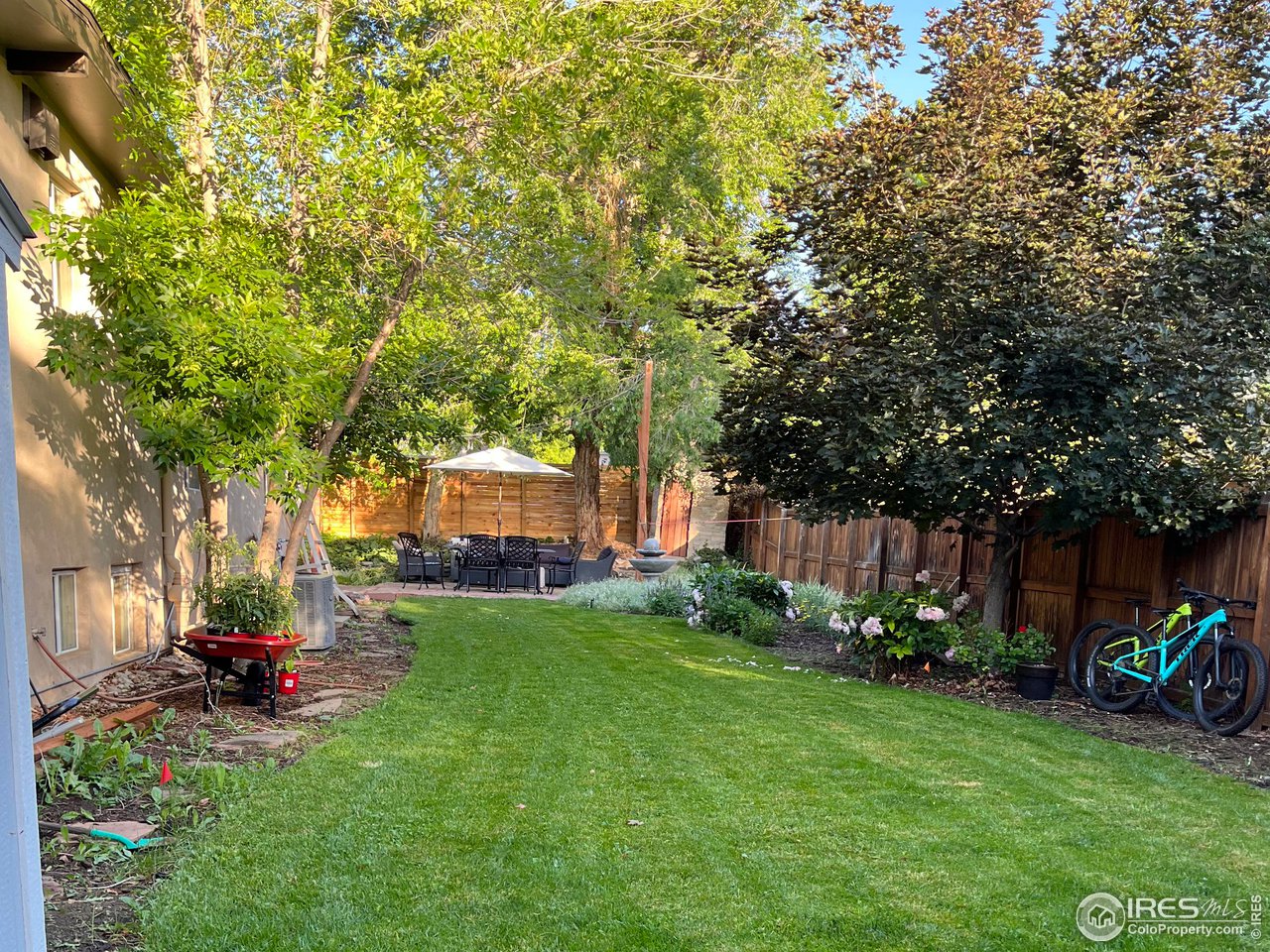 1895 Balsam Avenue Boulder, CO 80304 - Photo 16 of 40 a view of a backyard with table and chairs and potted plants and large trees