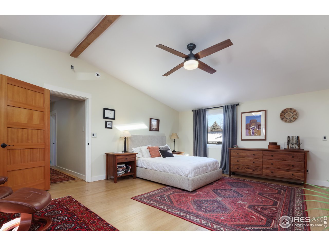 1895 Balsam Avenue Boulder, CO 80304 - Photo 18 of 40 a bedroom with a bed and a chandelier