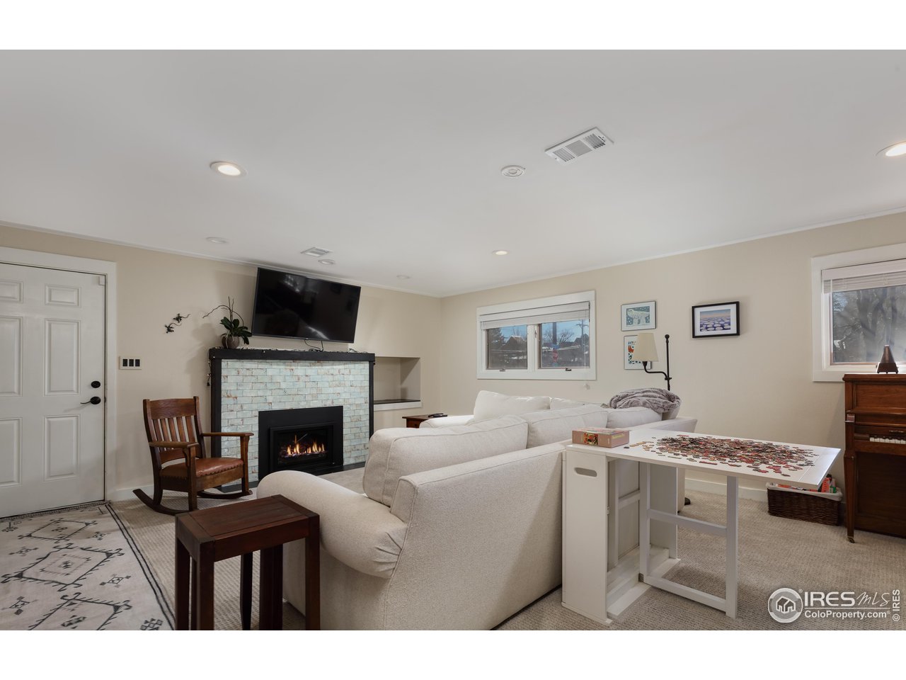 1895 Balsam Avenue Boulder, CO 80304 - Photo 27 of 40 a living room with furniture a fireplace and a flat screen tv