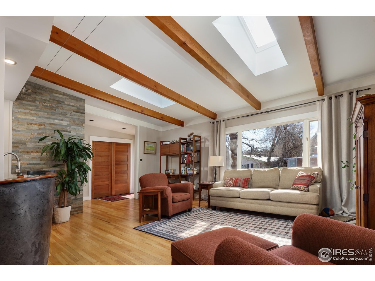 1895 Balsam Avenue Boulder, CO 80304 - Photo 4 of 40 a living room with furniture floor to ceiling window and a flat screen tv