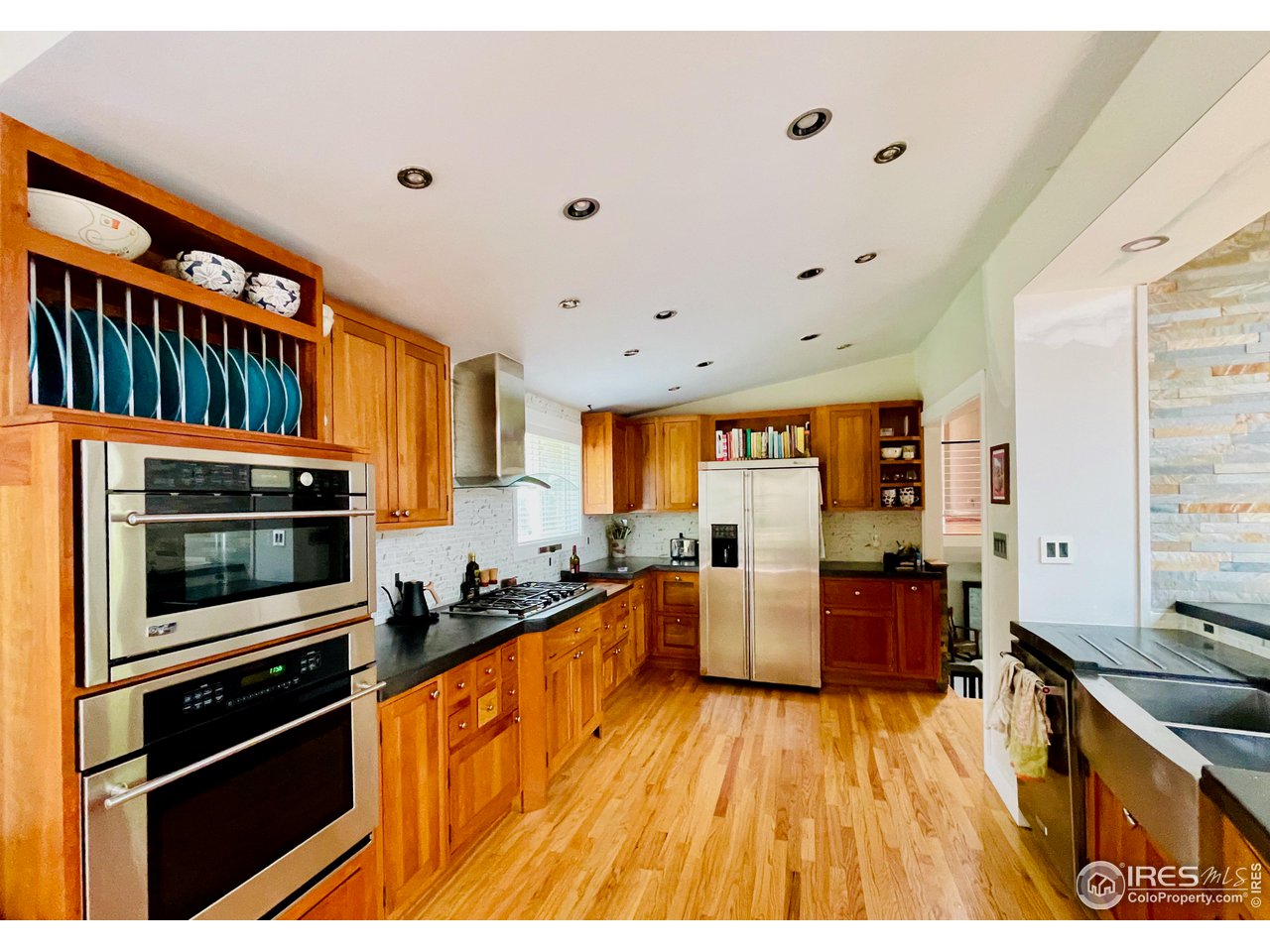 1895 Balsam Avenue Boulder, CO 80304 - Photo 6 of 40 a kitchen with stainless steel appliances a stove a sink dishwasher a refrigerator white cabinets and wooden floor