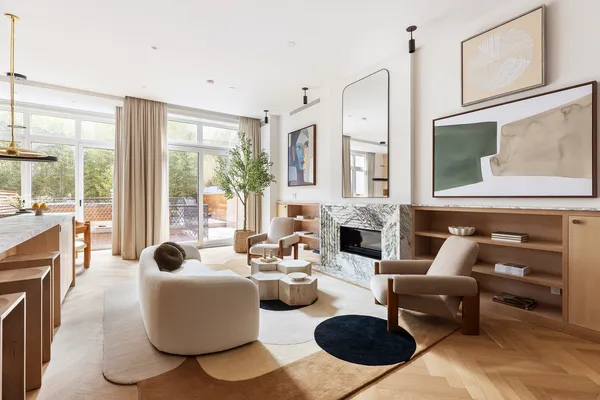 a living room with furniture a fireplace and a large window