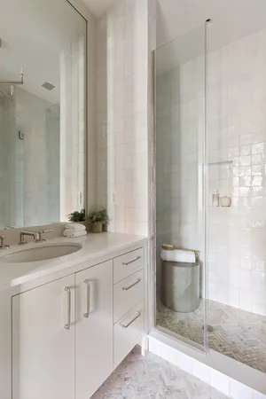 a view of an empty room with cabinet and a window