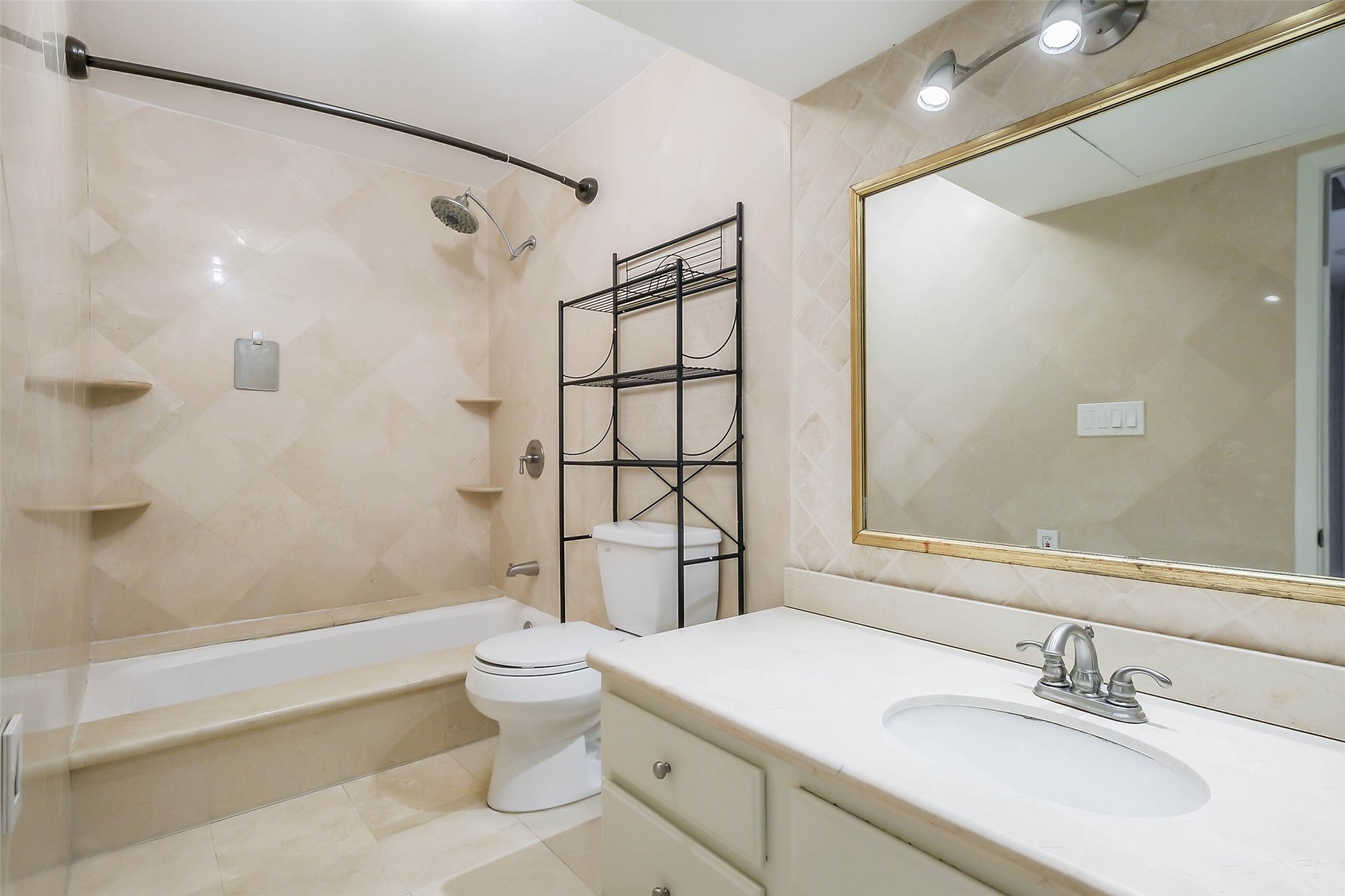 2230 South Piney Point Road, Unit 113 Houston, TX 77063 - Photo 17 of 28 The bathroom features tile floors and a garden tub+shower duo with tile surround.