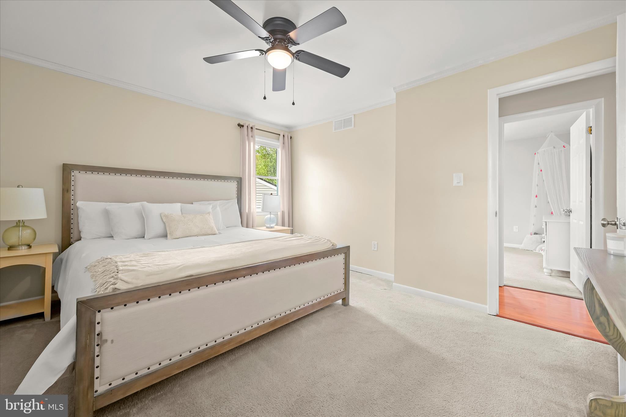 7533 Lemon Tree Court Hanover, MD 21076 - Photo 13 of 38 a bedroom with a large bed and a chandelier