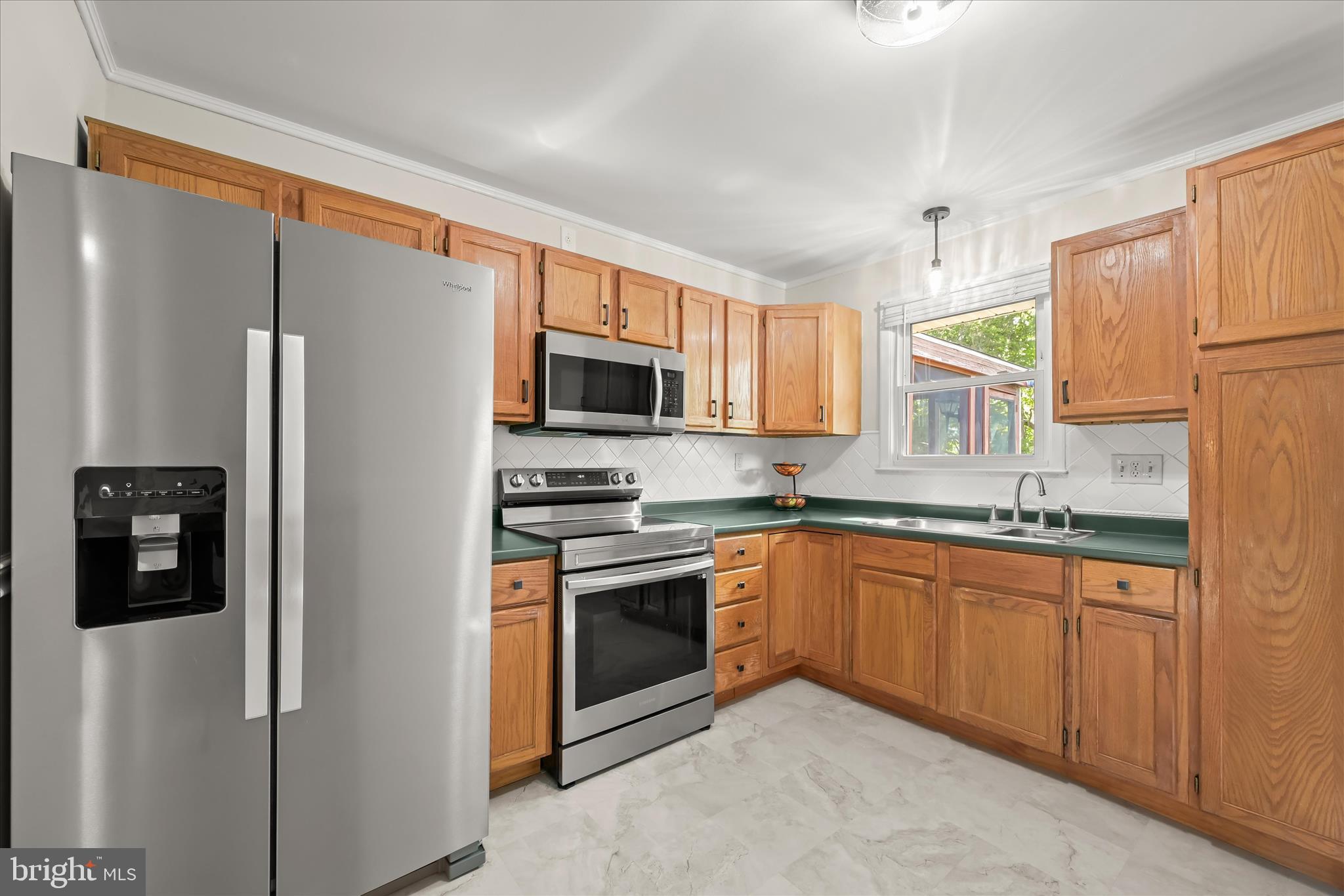 7533 Lemon Tree Court Hanover, MD 21076 - Photo 9 of 38 a kitchen with stainless steel appliances granite countertop a refrigerator a stove top oven a sink and dishwasher