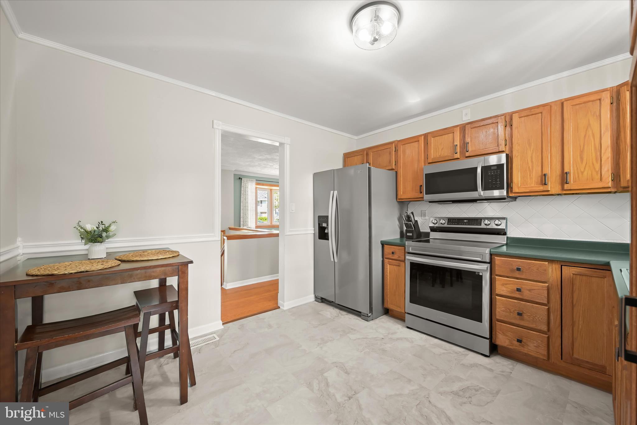 7533 Lemon Tree Court Hanover, MD 21076 - Photo 10 of 38 a kitchen with stainless steel appliances a stove a sink refrigerator and microwave