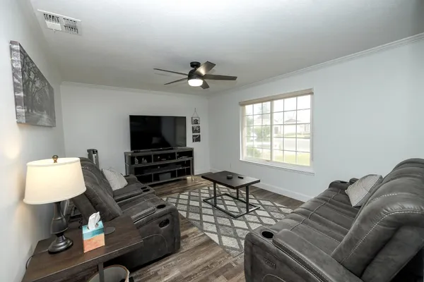 a living room with furniture and a flat screen tv