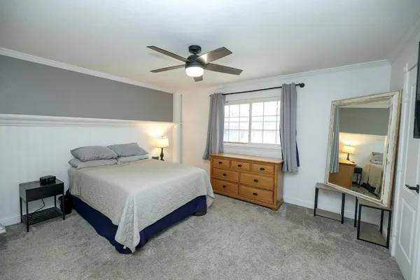 a bedroom with a bed and a chandelier
