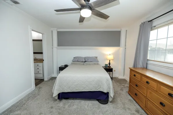 a bedroom with a bed and window