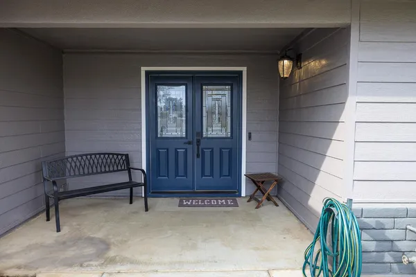 a view of front door and wooden bench