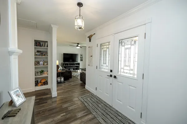 a view of a living room with furniture and wooden floor