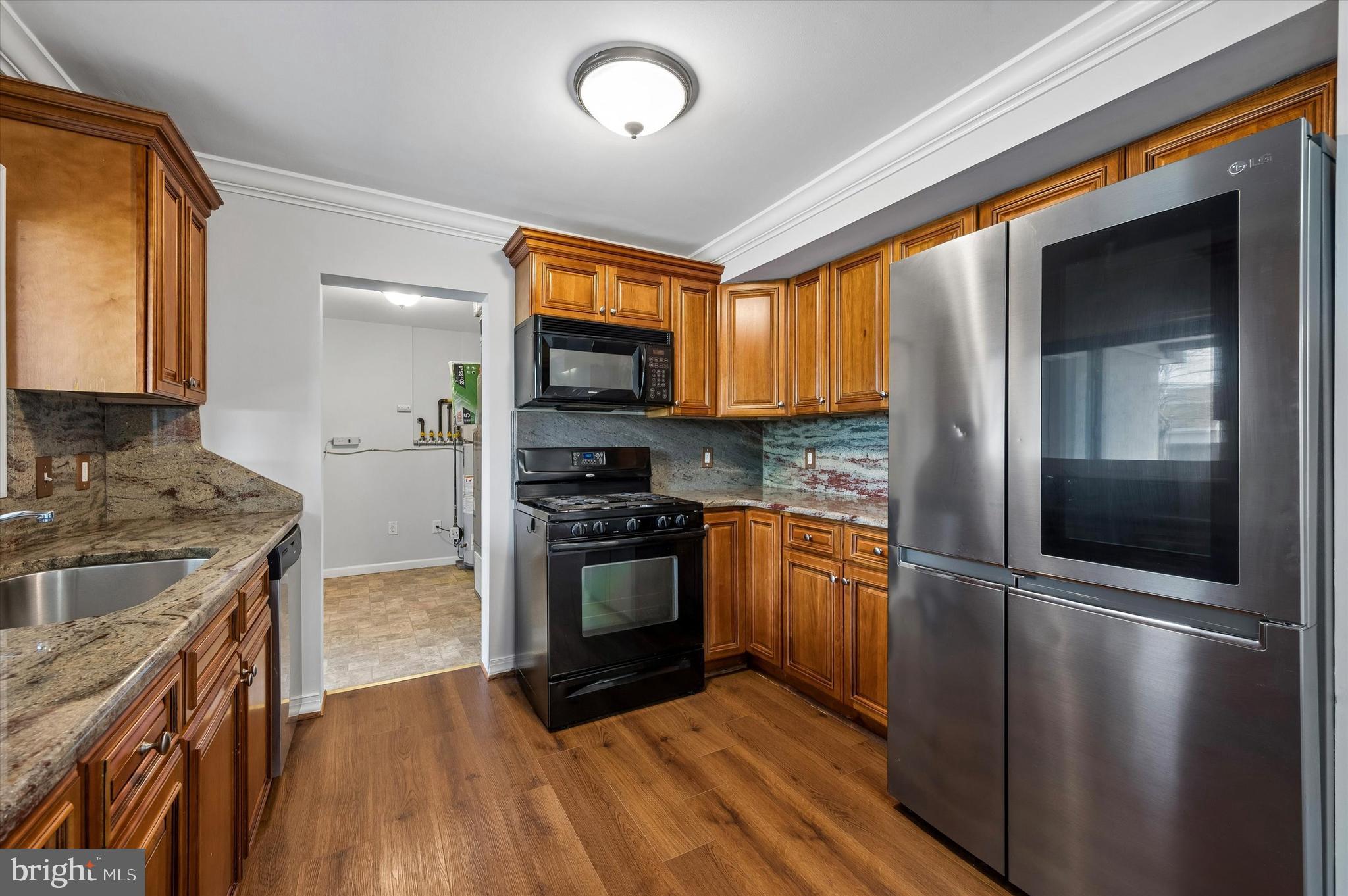 2154 Sproul Road Broomall, PA 19008 - Photo 11 of 25 a kitchen with stainless steel appliances granite countertop a refrigerator a stove and a sink