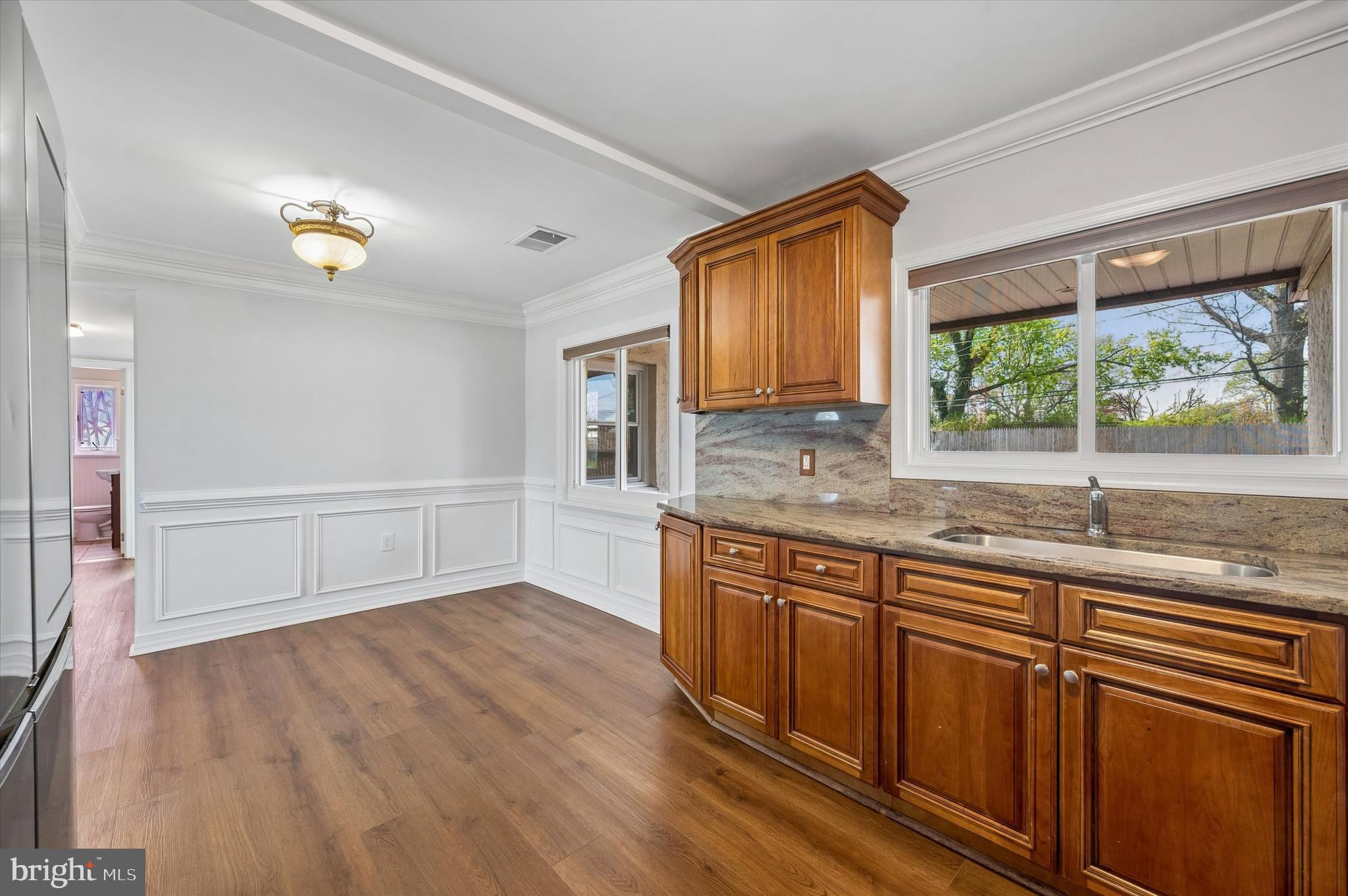 2154 Sproul Road Broomall, PA 19008 - Photo 12 of 25 a kitchen with granite countertop wooden cabinets a sink and a window