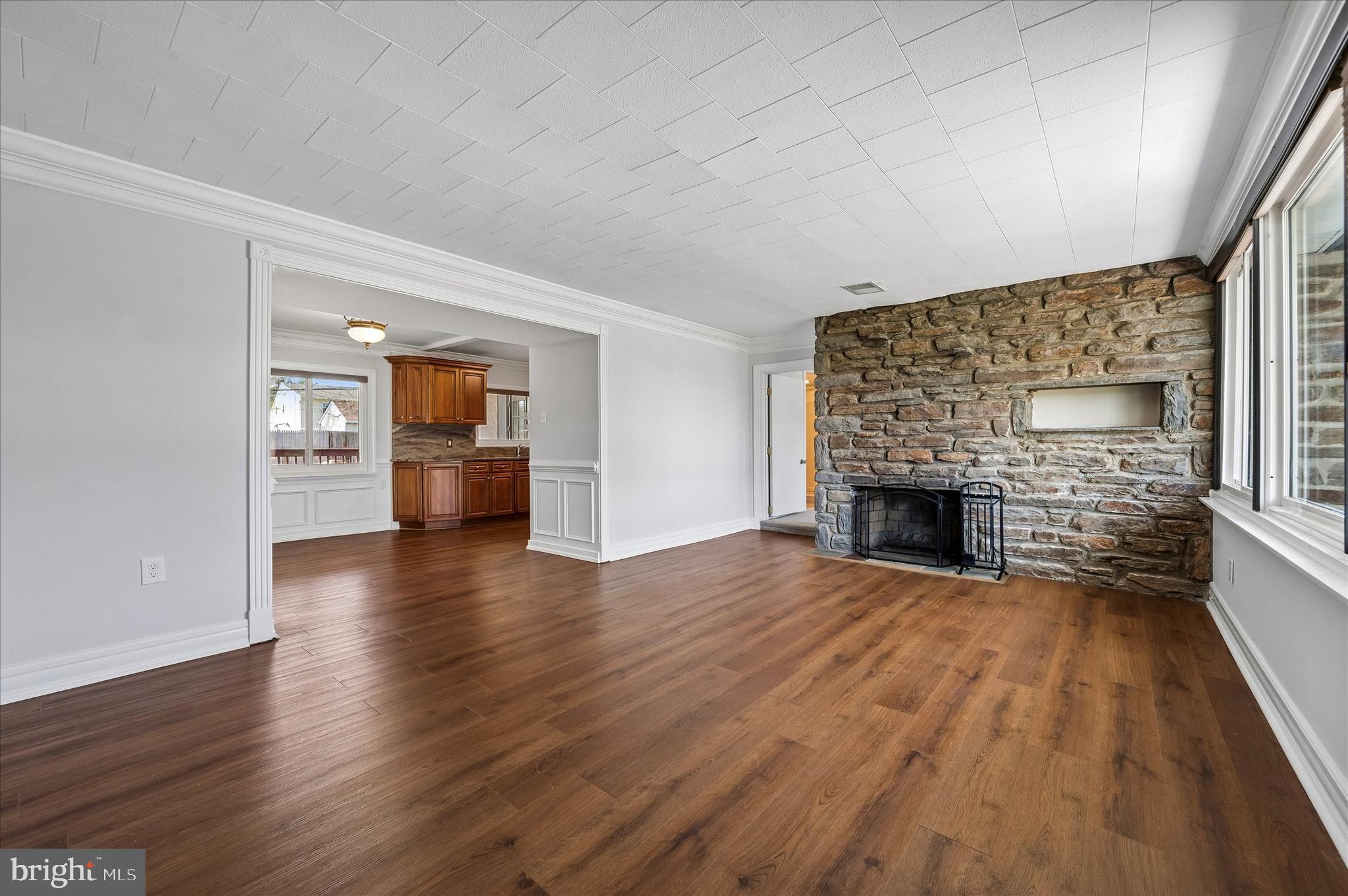 2154 Sproul Road Broomall, PA 19008 - Photo 3 of 25 a view of empty room with a fireplace and wooden floor