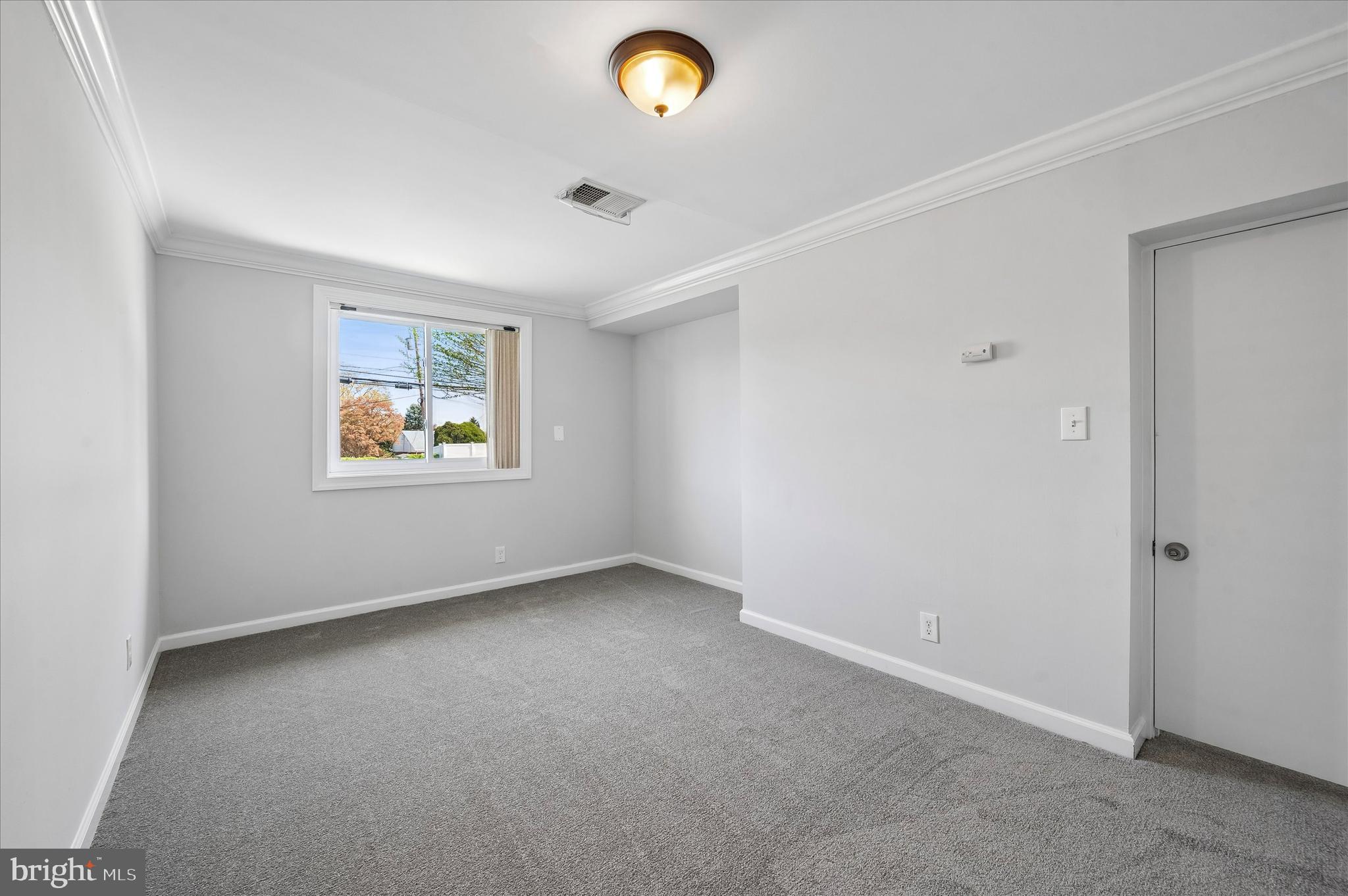 2154 Sproul Road Broomall, PA 19008 - Photo 6 of 25 an empty room with a window