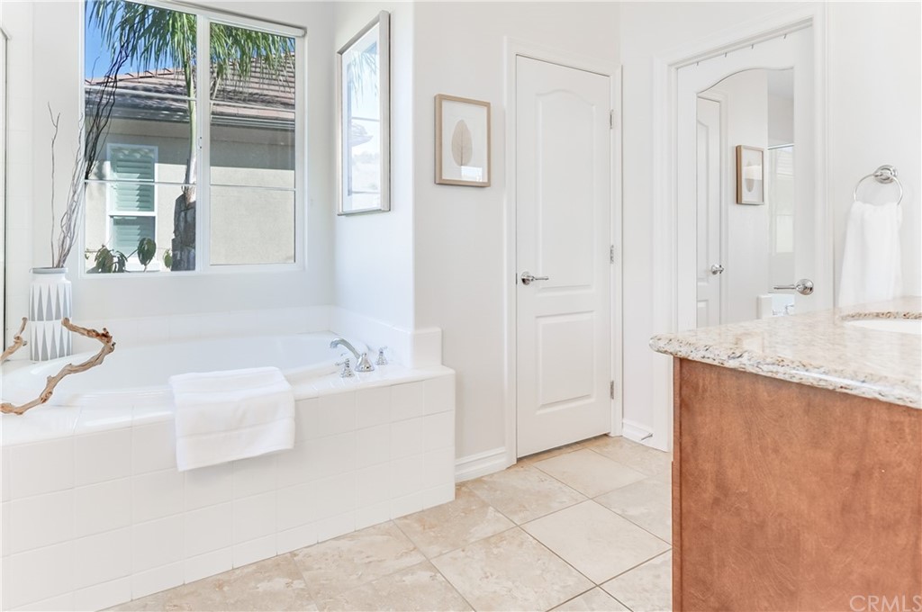 20 Paseo Canos San Clemente, CA 92673 - Photo 31 of 71 a bathroom with a granite countertop sink and a bathtub
