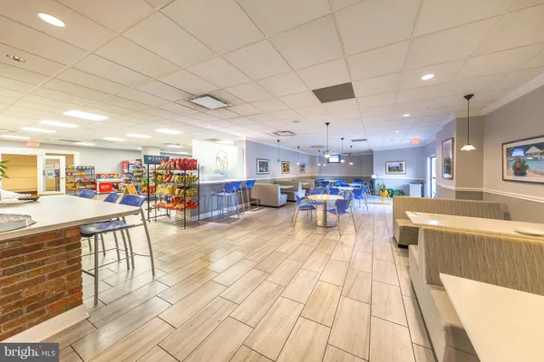 a view of a living room and kitchen floor to ceiling windows