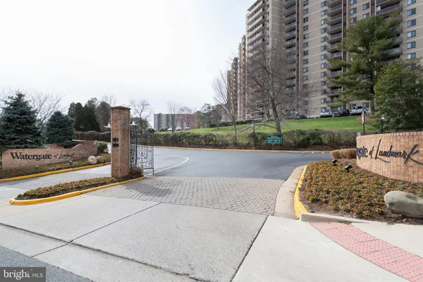 a view of a patio with table and chairs under an umbrella with wooden fence