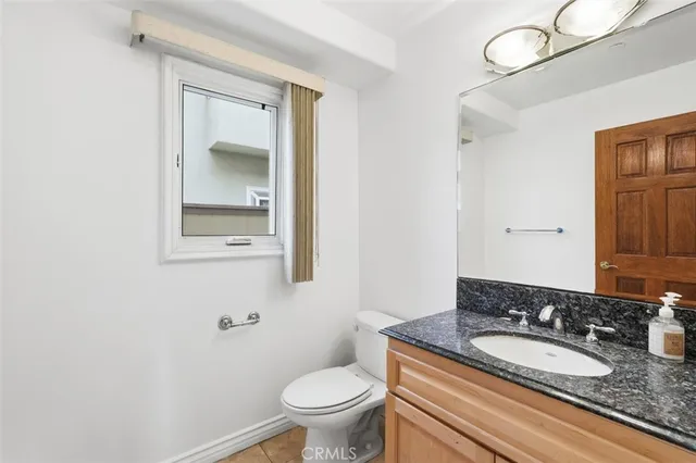 a bathroom with a granite countertop sink a mirror and a shower