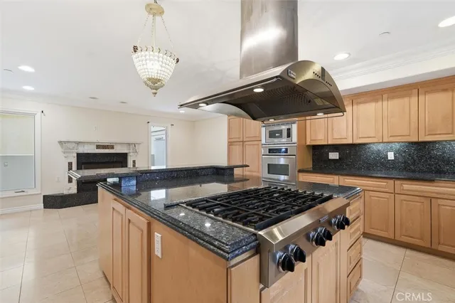a kitchen with a stove and a chandelier