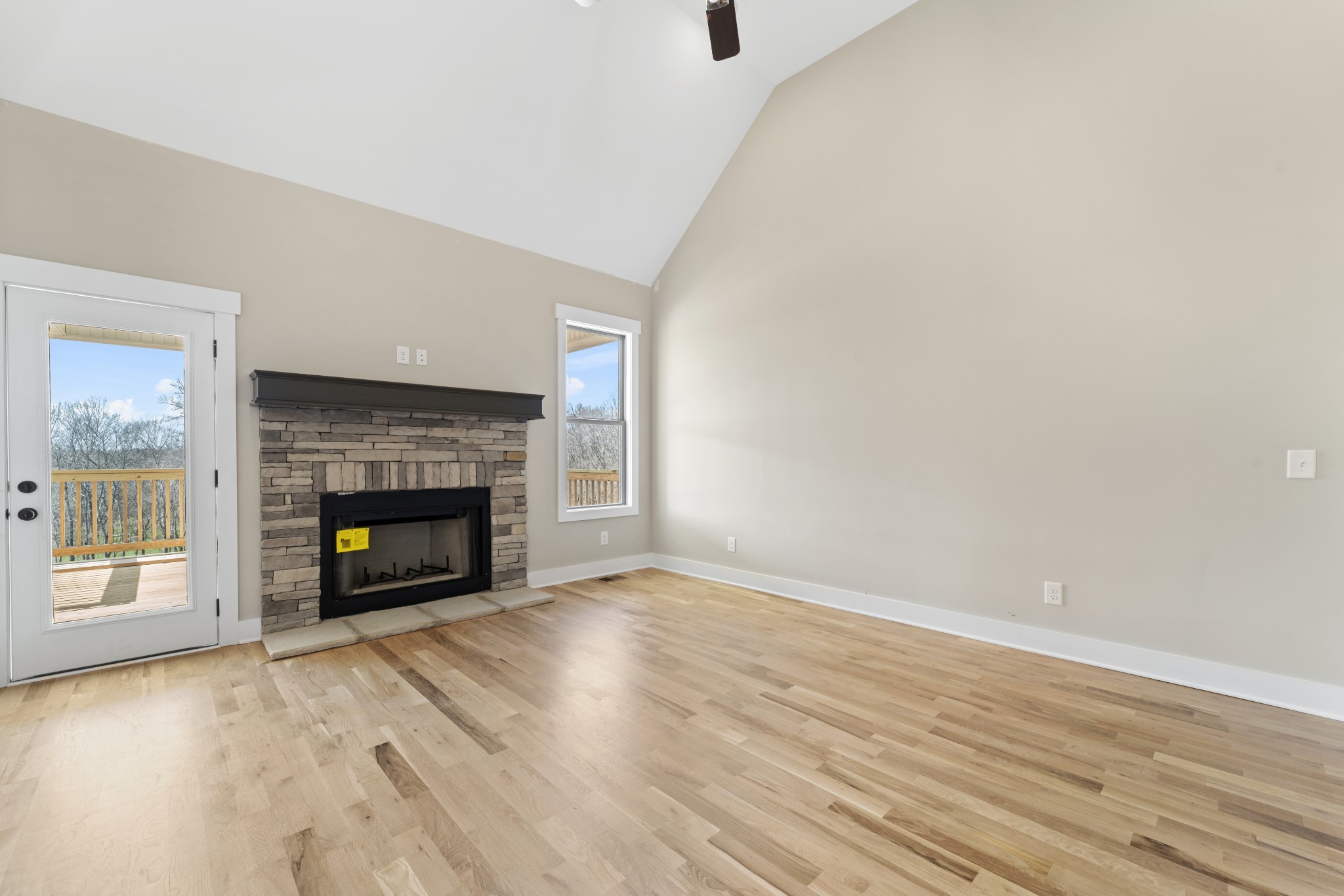 6120 Red River School Road Portland, TN 37148 - Photo 5 of 26 a view of an empty room with wooden floor fireplace and a window