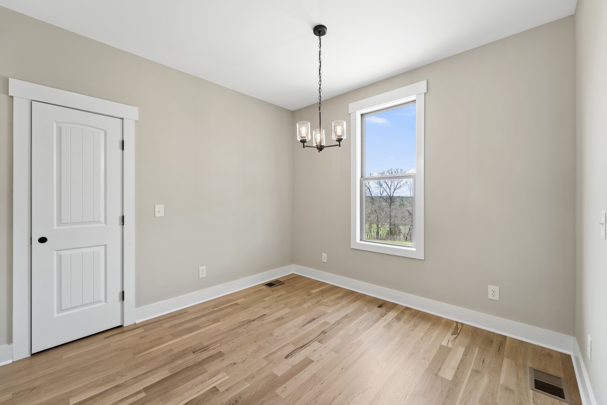 6120 Red River School Road Portland, TN 37148 - Photo 9 of 26 a view of an empty room with wooden floor and a window