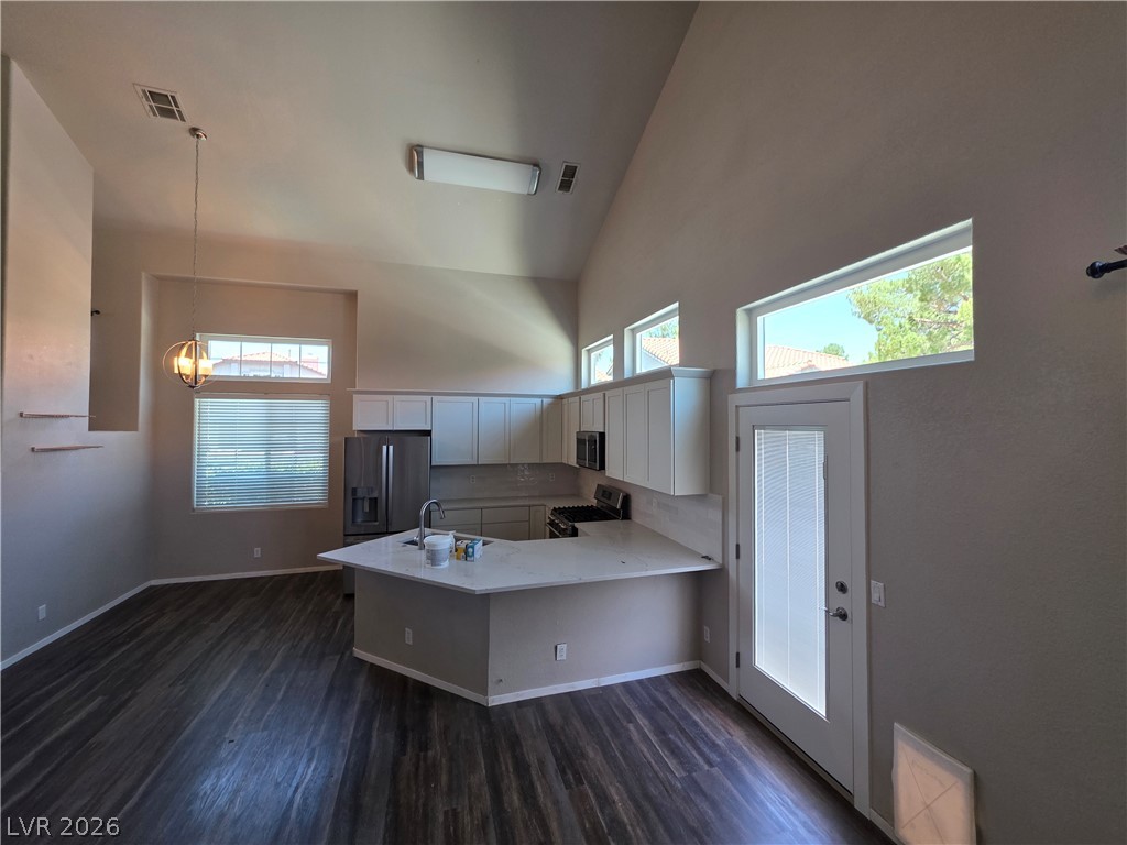 2275 Ramsgate Drive Henderson, NV 89074 - Photo 33 of 84 A contemporary kitchen space boasts vaulted ceilings, rich hardwood flooring, and ample natural light.