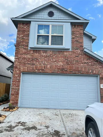 a front view of a house with parking space