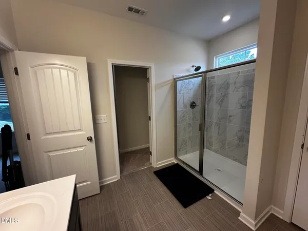 a bathroom with a shower and a mirror