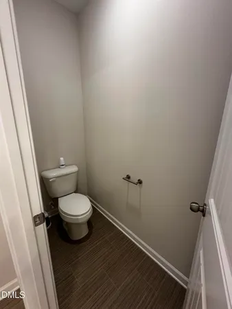 a white toilet sitting next to a small sink