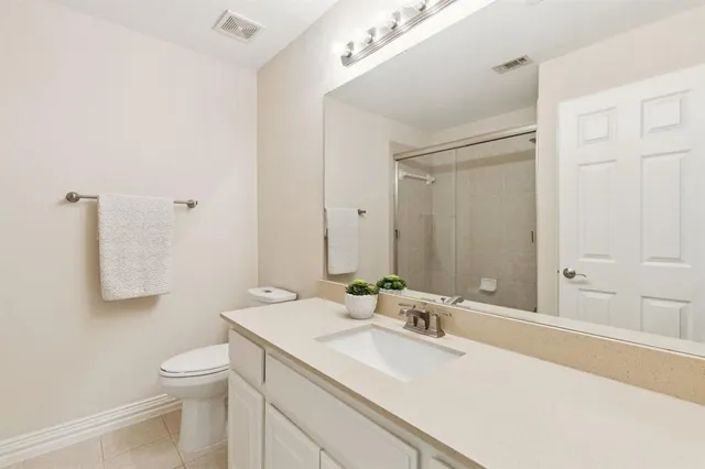 a bathroom with a sink toilet and mirror