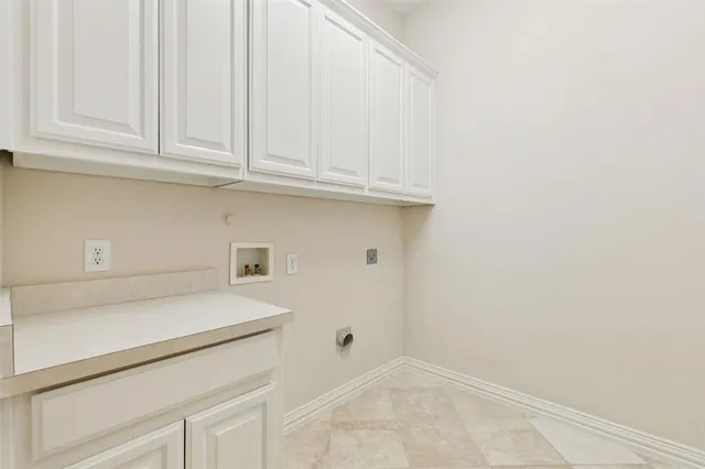 a view of a kitchen with white cabinets