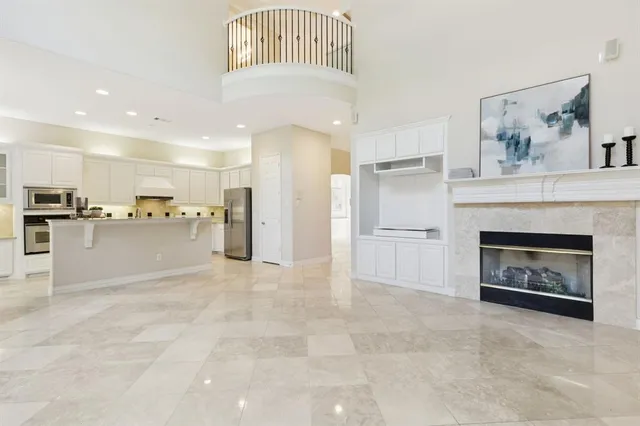 a view of a kitchen with a sink and a fireplace