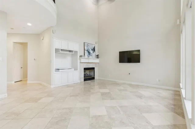 a view of kitchen with stainless steel appliances cabinets and empty shelves