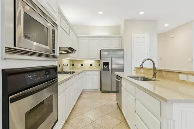 a kitchen with a sink stove and refrigerator