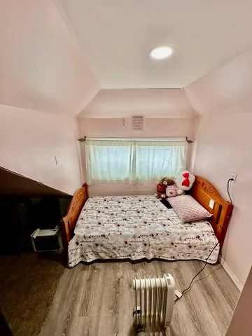 a bedroom with a bed and window