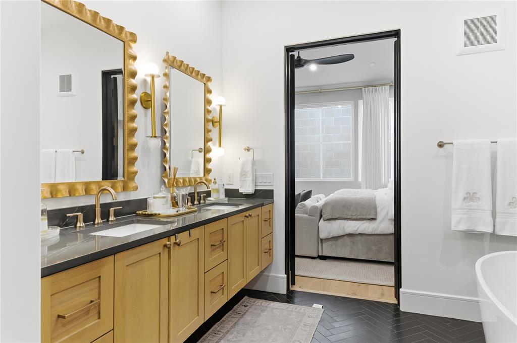 320 O Connor Ridge Boulevard, Unit 22 Irving, TX 75038 - Photo 23 of 34 a en suite bathroom with a double vanity sink and a mirror