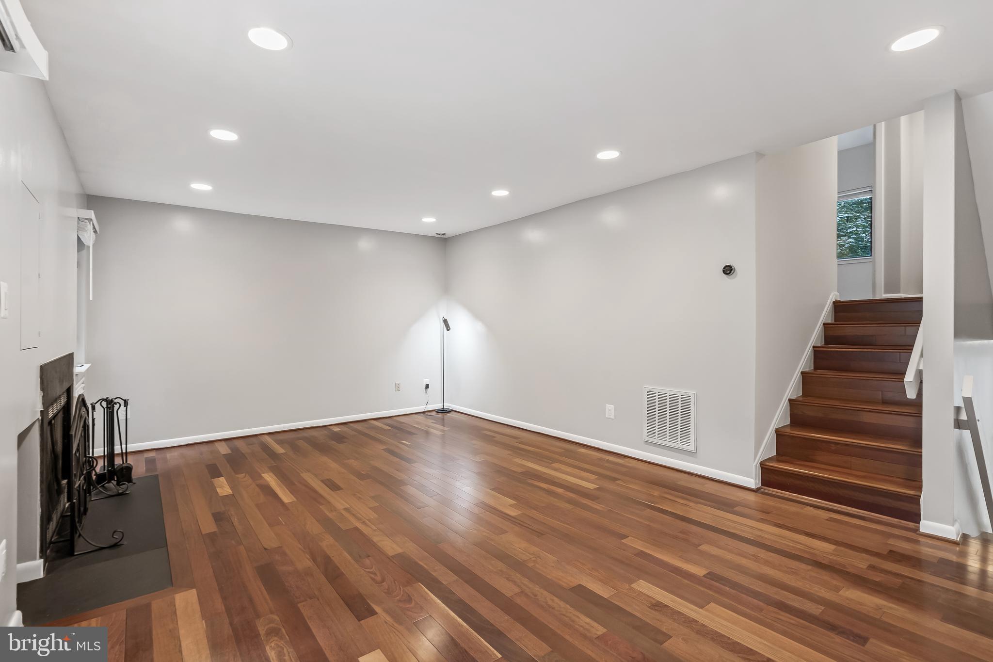 11019 Thrush Ridge Road Reston, VA 20191 - Photo 13 of 28 a view of an empty room with wooden floor and stairs