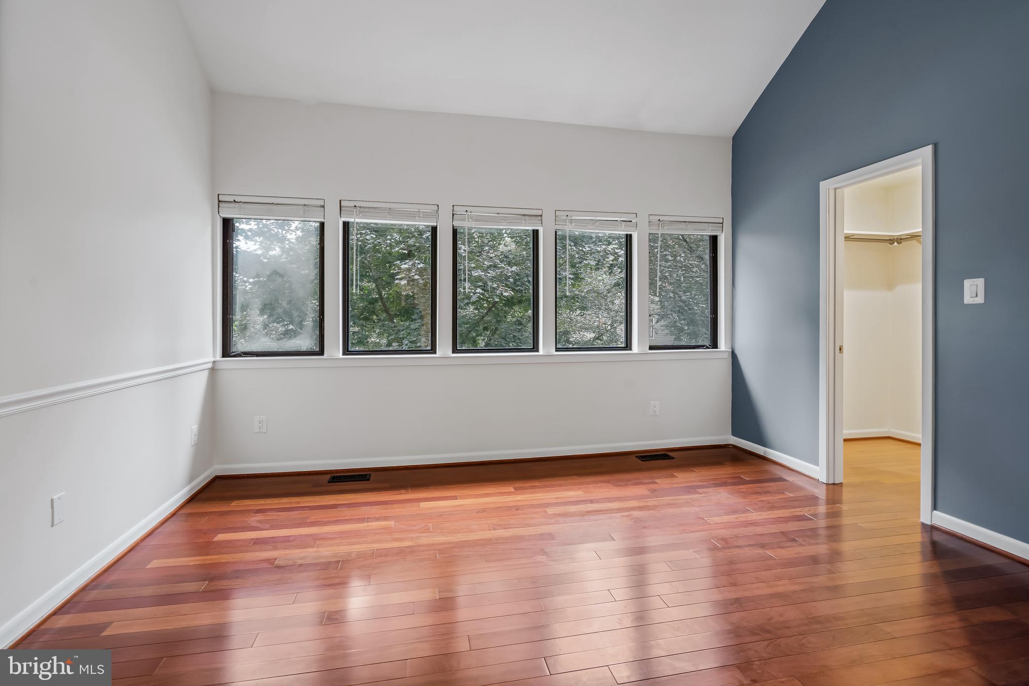 11019 Thrush Ridge Road Reston, VA 20191 - Photo 16 of 28 an empty room with wooden floor and windows