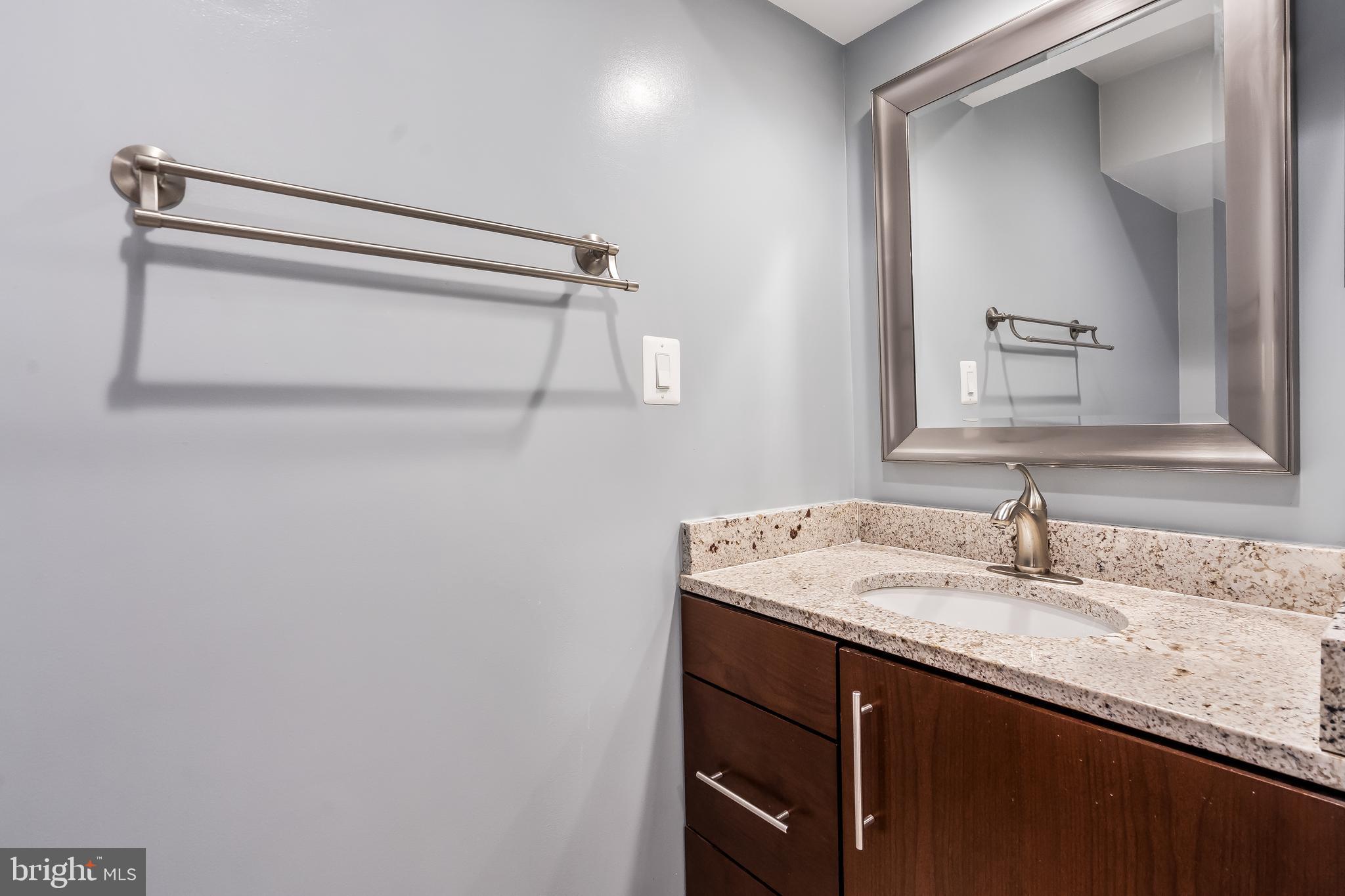 11019 Thrush Ridge Road Reston, VA 20191 - Photo 20 of 28 a bathroom with a granite countertop sink and a mirror