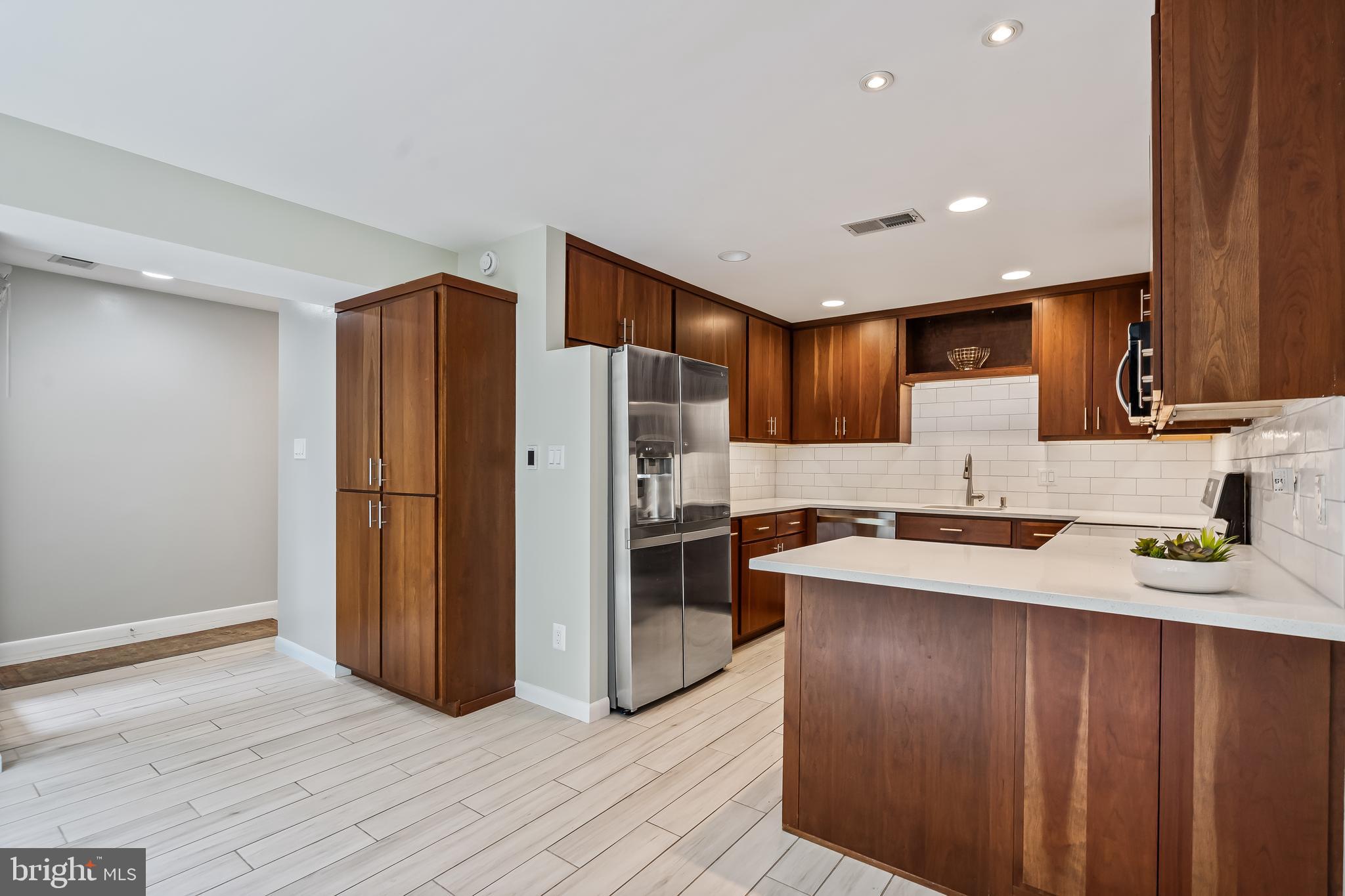 11019 Thrush Ridge Road Reston, VA 20191 - Photo 7 of 28 a kitchen with stainless steel appliances a refrigerator sink and microwave