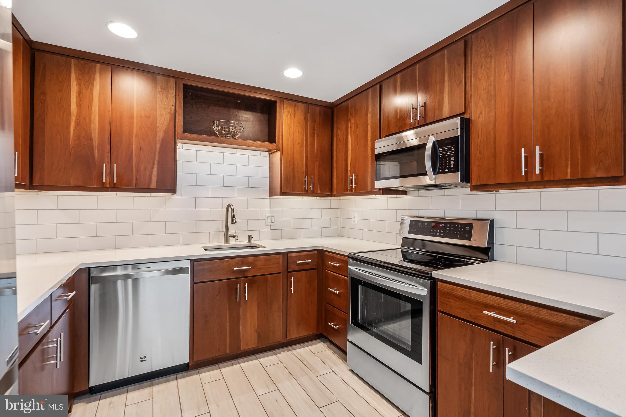11019 Thrush Ridge Road Reston, VA 20191 - Photo 8 of 28 a kitchen with sink cabinets and stainless steel appliances