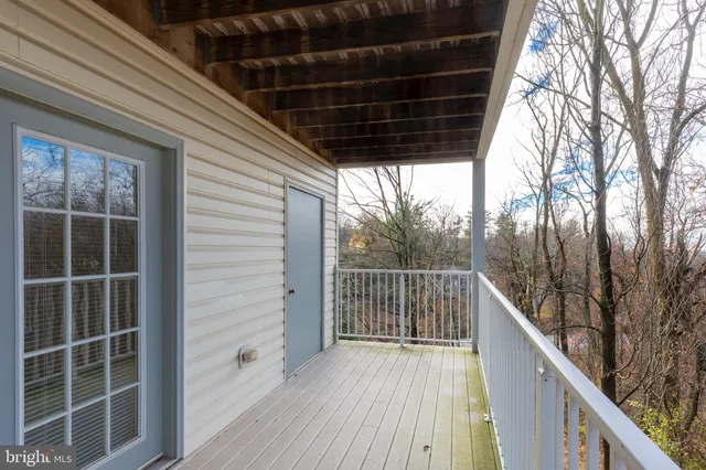 a view of balcony with wooden floor and fence