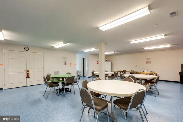 a dining room with furniture and a chandelier