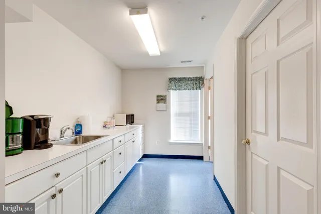 a kitchen with cabinets a sink and a window